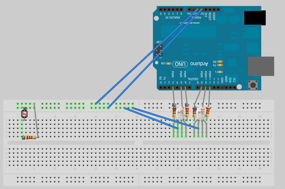 Original breadboard layout showing the Arduino Uno, light sensor, LEDs, resistors, and connecting wires